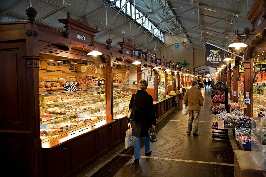 Shoppers at the counters inside Helsinki's Vanha Kauppahalli