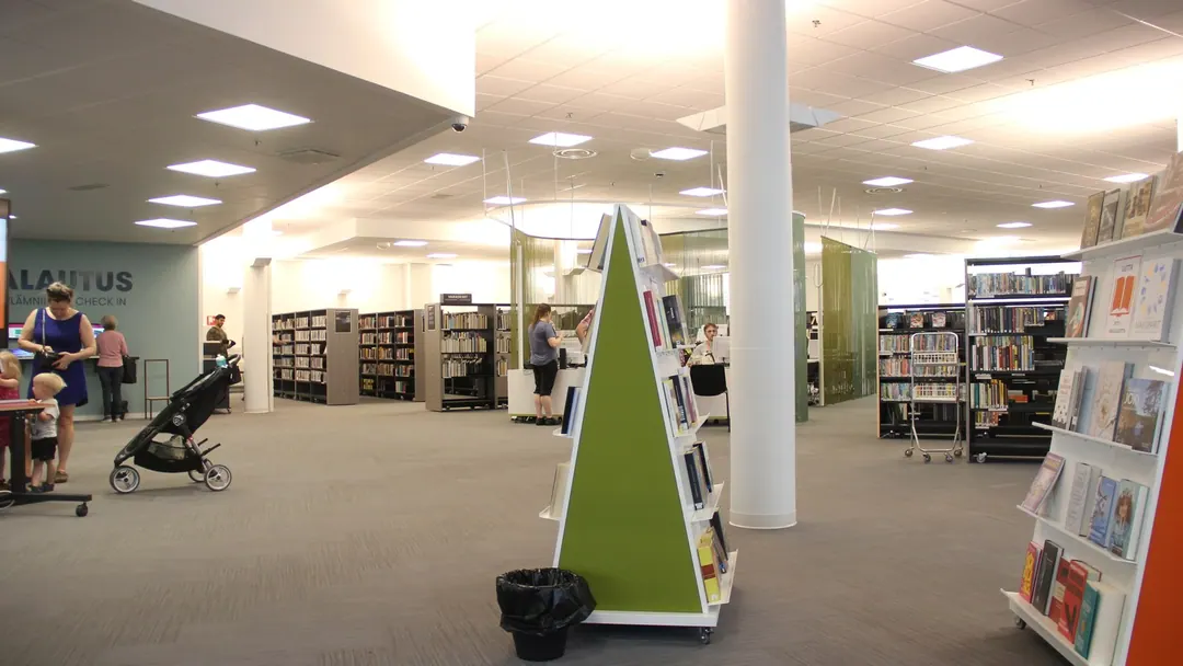 The reading floor of Myyrmaki library in Vantaa, tables and shelves under a high window