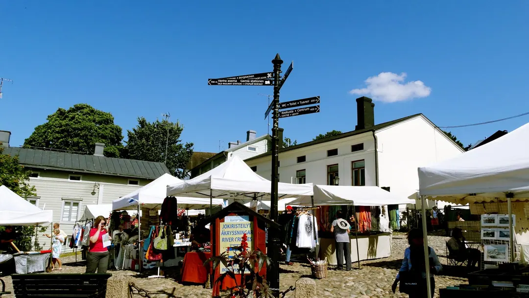 Stalls and shoppers at the market in Porvoo on a summer day