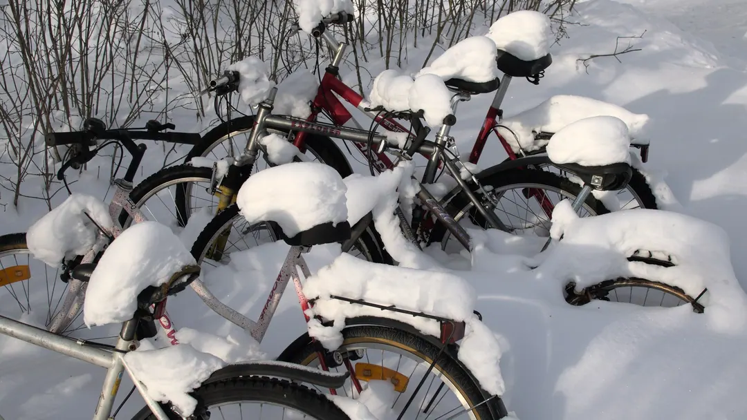 Bicycles buried up to the handlebars in a snowdrift on a Helsinki street