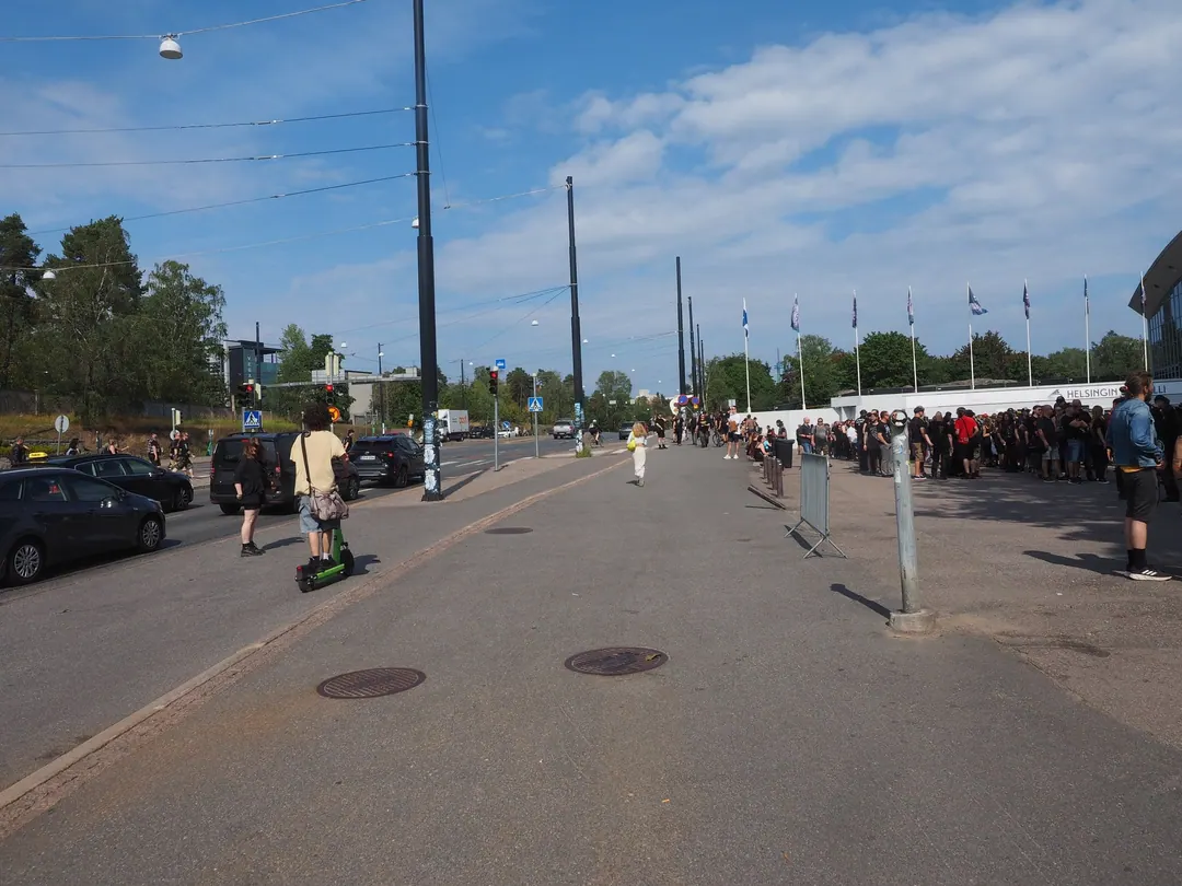 A queue down Nordenskiöldinkatu in Helsinki for a heavy metal concert on a summer evening