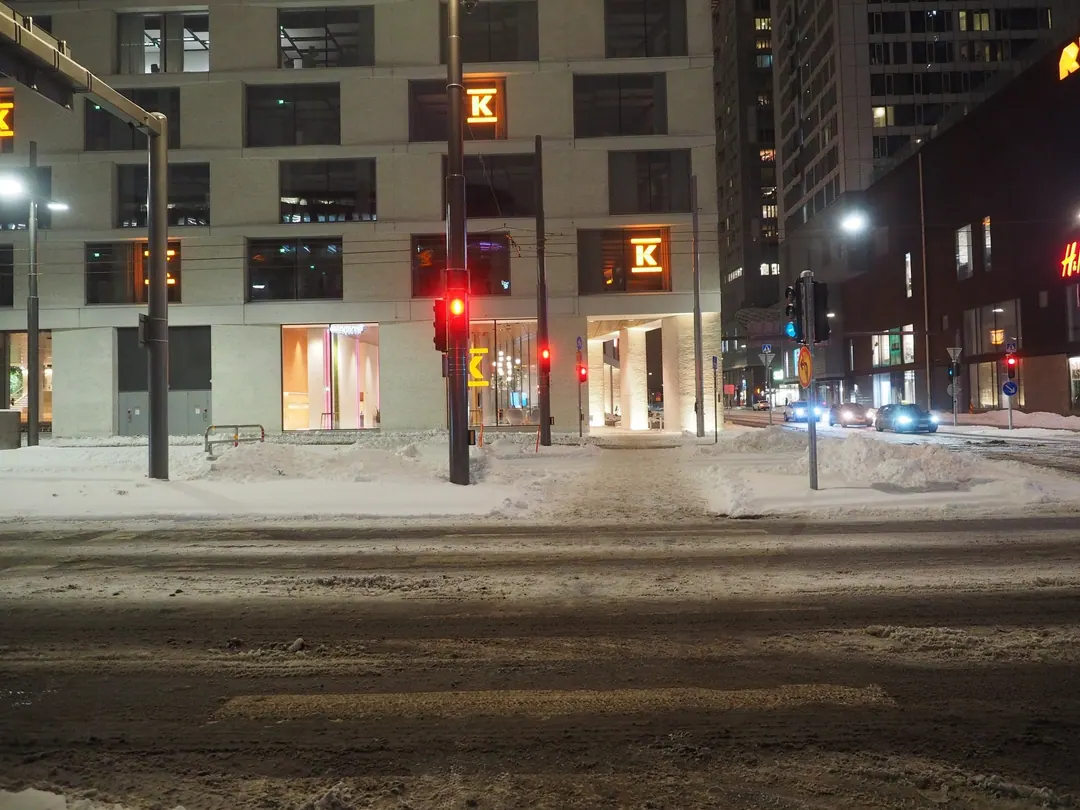 The K-Kampus corporate headquarters in Helsinki lit from inside on a February evening