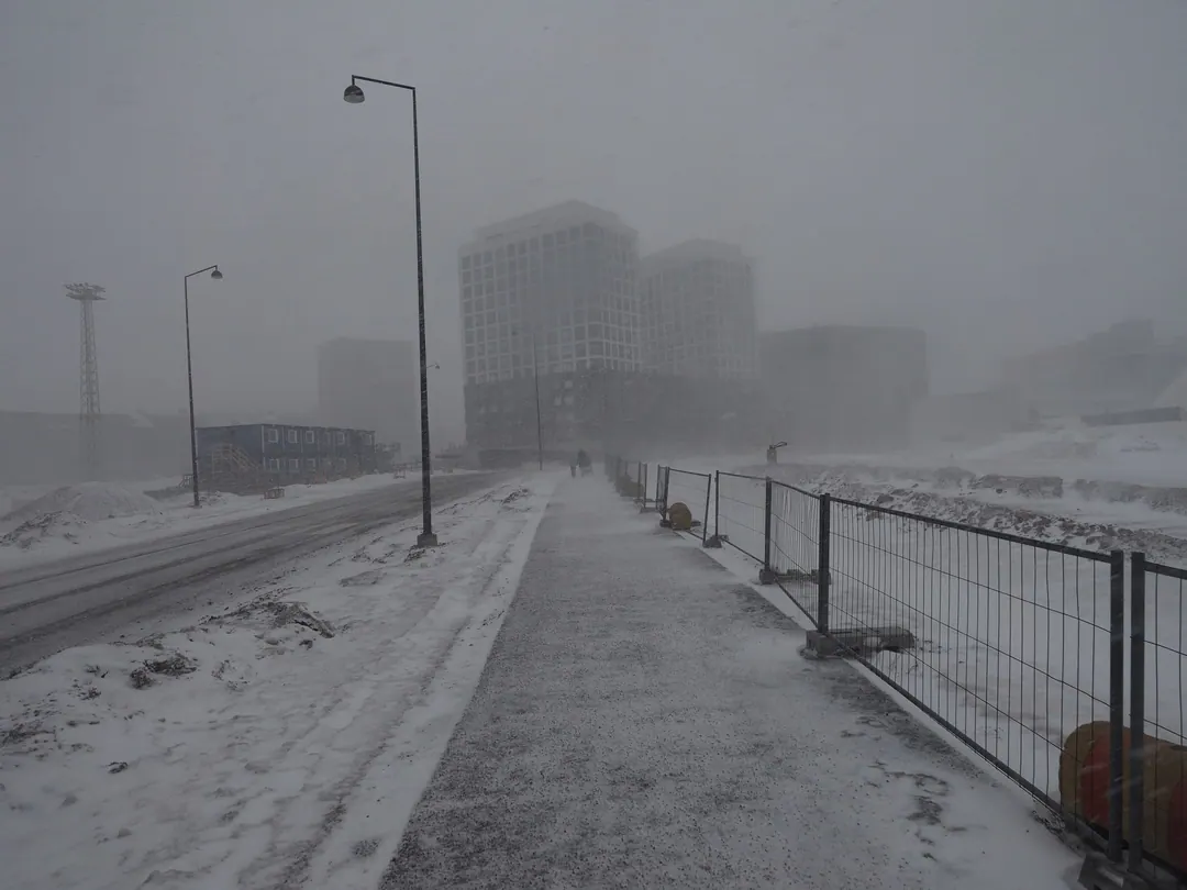 Snow blowing across Jätkäsaari in Helsinki during a blizzard, buildings barely visible