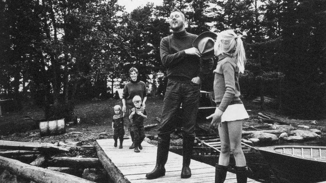 Writer Henrik Tikkanen talking with his family by the water in 1966