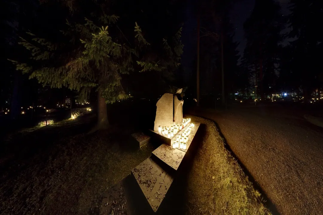 Candles surrounding a stone memorial at Siilinjärvi cemetery on All Saints' Day
