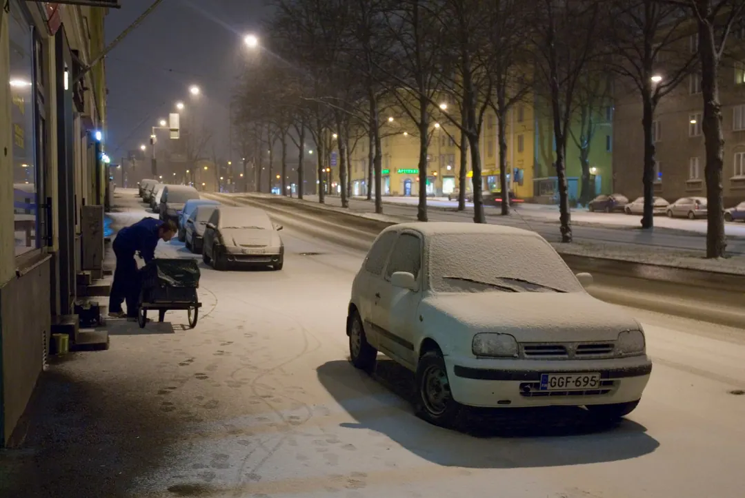 A Helsingin Sanomat delivery worker on an early-morning round on Mäkelänkatu, Helsinki, 2008